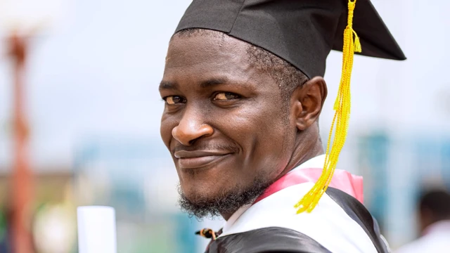 Young African graduate holding a qualification