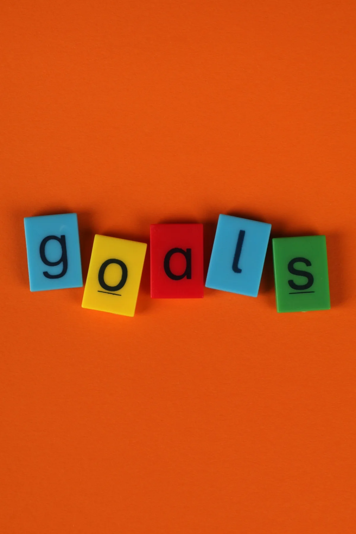 Colourful letter tiles spelling goals