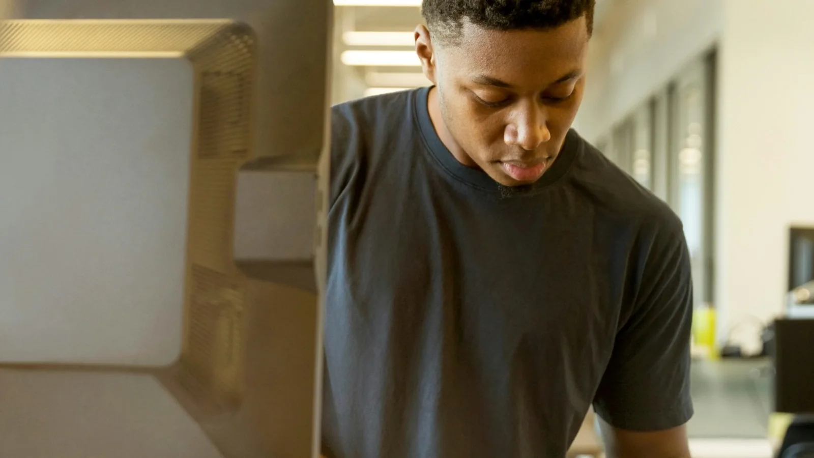 Student reviewing written notes beside a computer